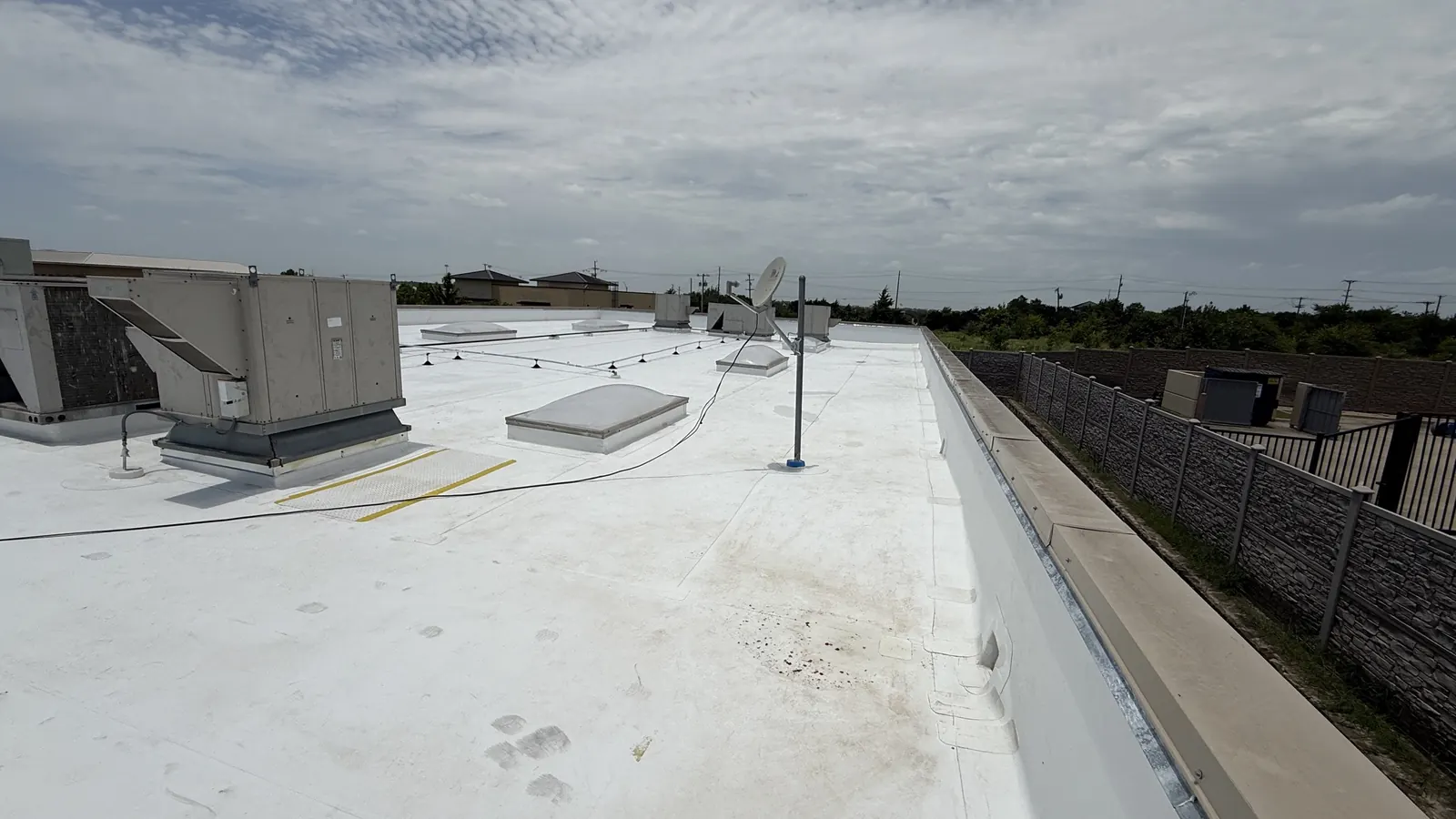 TPO roof parapet and coping inspected during a commercial roof service visit